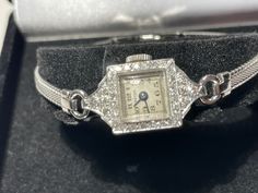 "Fabulous Art Deco ladies diamond platinum wristwatch. This antique watch has a 17 jewel hand winding Swiss movement that is in good working condition keeping accurate time. The case is solid platinum with 32 diamonds in a pave halo design. The attached band is stainless steel and custom fit for a 6.5\" wrist. The dial has Arabic numbers in black and is signed Croton. A A fabulous classy antique working timepiece." Art Deco Ladies, Arabic Numbers, Art Deco Watch, Antique Watch, Art Deco Lady, Halo Design, Antique Watches, Salisbury, Women Wrist Watch