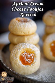 apricot cream cheese cookies are stacked on top of each other with powdered sugar