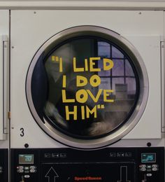 a washing machine with the words i led i do love him written in yellow on it