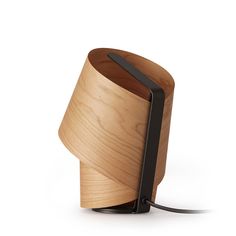 a wooden table lamp with a black metal holder on the side and a white background