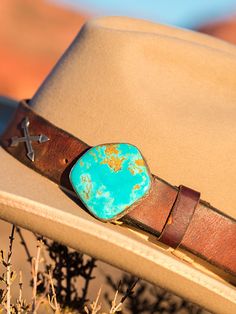 This band is what started it all! Our Pinnacle band on vintage latigo leather is such a statement piece! I couldn't see all the latigos on our ranch getting thrown out and visualized a large geometric piece of turquoise as a buckle, and made it happen. Theses chunks of Kingman turquoise are outstanding and I find the ranchiest leather possible! You will love it! We can add any western charms to the bands, Arrows, Conchos, or Bucking horses. Southwestern Leather Belt Buckles For Rodeo, Rustic Leather Belt Buckles For Rodeo, Southwestern Leather Belt Buckles For Western-themed Events, Vintage Adjustable Turquoise Belt, Adjustable Vintage Turquoise Belt, Adjustable Turquoise Vintage Belt, Adjustable Artisan Leather Belt Buckles, Southwestern Style Leather Belt With Antique Buckle, Western Turquoise Belt With Concho