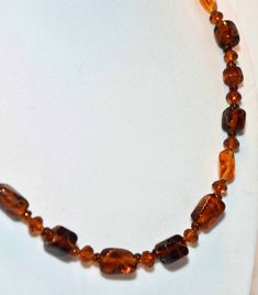 A beautiful amber colored specialty glass beaded necklace.  A mixture of brown ambercolored barrel & oval painted glass beads,  golden amber colored faceted glass & golden amber colored crystal beads.   Made with a sterling silver spring ring clasp with a adjustable chain catch, necklace is adjustable from 19-22 inches.  Matching earrings are made on sterling silver sheppard hooks & have a 1.75" drop.      This is a really pretty set...my pictures do not show this well.  IMPORTANT TO NOTE:  I DO NOT MASS PRODUCE!  Most pieces are a 1 or 2 of a kind.    THIS IS NOT COSTUME JEWELRY.   You will not be disappointed with my designs.   I make all of my beaded jewelry with good quality materials...genuine semi-precious gemstones, Swarovski Crystals, Sterling Silver, Specialty glass.  Most pieces Amber Beaded Necklace With Large Beads As Gift, Brown Glass Beads For Jewelry Making, Amber Beaded Necklaces With Large Beads For Gifts, Brown Single Strand Beads For Gift, Amber Oval Beads Single Strand Necklace, Brown Oval Beads Jewelry For Gift, Amber Single Strand Necklace With Oval Beads, Brown Single Strand Beads As Gift, Amber Czech Glass Jewelry With Polished Beads