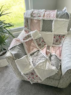 a chair covered in patchwork fabric next to a potted plant