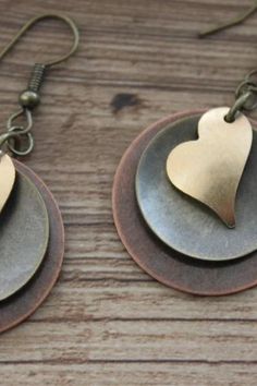 Finish : Antiqued Copper coin drop ( 25 mm or 1 inch ) , Antique brass disc and antique brass Heart. Length: 2 inches including the antique brass hooks ear wires The antique copper and brass discs have been domed by myself. Please check out my Valentine gift for her section for more choices : https://www.etsy.com/shop/NtikArtJewelry?ref=seller-platform-mcnav§ion_id=36789575 Thanks for looking !!! Metal Heart Pendant Earrings For Anniversary, Metal Heart Pendant Jewelry With Matching Earrings, Heart Charm Earrings For Jewelry Making, Metal Jewelry With Matching Heart Pendant Earrings, Heart Charm Drop Earrings For Mother's Day, Heart Pendant Jewelry With Matching Earrings, Heart Pendant Jewelry Set With Matching Earrings, Mother's Day Heart Pendant Earrings For Pierced Ears, Valentine's Day Metal Drop Earrings