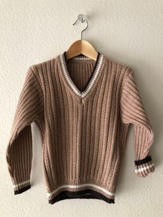 A fantastic 1960s sweater featuring a cable knit design and V neckline. In excellent condition!  No stains, snags etc. Would look amazing layered or by itself. No tags, but most likely will fit a range from 4T-5. As always, please see pictures of approx. measurements.    Feels to be an acrylic/wool blend~ +Why buy Vintage? Aside from owning something most likely is one of a kind; it is also a great opportunity for optimal recycling - a great way to not add to the mass overproduction, and to help Vintage V-neck Knit Sweater, Vintage Long Sleeve V-neck Sweater For Winter, Retro Long Sleeve Ribbed Sweater, Retro Cable Knit Sweater For Fall, Vintage V-neck Sweater For Fall, Retro Long Sleeve V-neck Sweater For Winter, Retro Ribbed Knit Sweater, Vintage Sweater With Ribbed Collar For Fall, Vintage Knit Sweater With Ribbed Collar