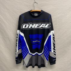 a blue and black jersey hanging on a white wall with the word oneal printed on it