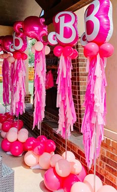 balloons and streamers are on display in front of the fireplace for an 85th birthday party