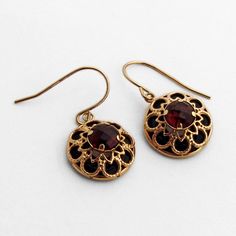 "Vintage 14 K (.585) yellow gold round form drop earrings in open-work designs, having checkerboard cut Garnet centerpiece and carved donut form Onyx inset underneath. These splendid earrings are 1\" long (including the hook) and 9/16\" in diameter, weighing a total 2.9 grams. EA1492" Garnet Drop Earrings, Upcycled Vintage Jewelry, Antique Gold Earrings, Vintage Drop Earrings, Bronze Jewelry, Garnet Jewelry, Art Deco Earrings, Antique Earrings, Big Sister