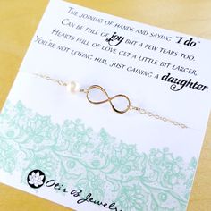 a card with a necklace on it that says, the bond of hands and saying i do