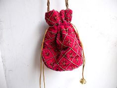 "Velvet evening purse with handwork of golden beads. Crossbody party bag with drawstring at the closure. It has an ethnic Indian touch in style and will go with western wears also like with dresses, jeans, etc. The bag is made up of velvet cloth in different color. It has a sling to hang it on the go. Can be used to gift some one or as fancy small sling bag in party or wedding. It can carry small things like mobile, wallet, etc. Dimension: maximum vertical length (of purse): 7\" vertical length Elegant Festival Bags Suitable For Gifts, Elegant Festival Bags For Gifts, Gold Handwork Potli Bag For Evening, Elegant Festival Gift Bags, Bohemian Beaded Potli Bag For Wedding, Embroidered Pouch Potli Bag For Party, Pink Shoulder Bag With Handwork For Party, Traditional Beaded Pouch Clutch, Beaded Rectangular Potli Bag For Festive Occasions