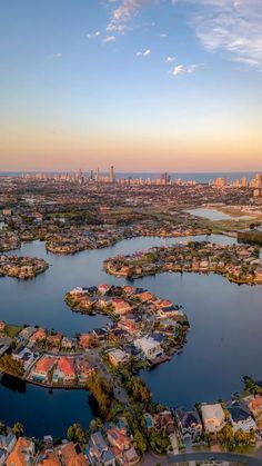 an aerial view of a city and lake at sunset