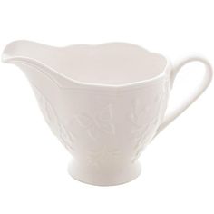 a white porcelain gravy dish on a white background