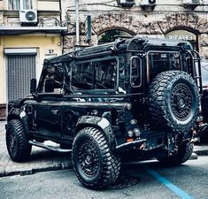 a black jeep parked in front of a building