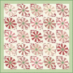 a quilt with red and green designs on it