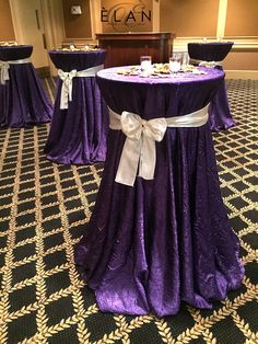 the tables are covered with purple cloths