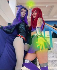 two women dressed in costumes posing for the camera