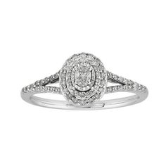 a white gold ring with diamonds on the band and an oval shaped center stone in the middle