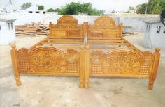 a wooden bed frame sitting on top of a cement floor