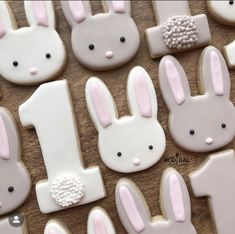 decorated cookies with bunny and rabbit ears on a wooden table, including one for the first