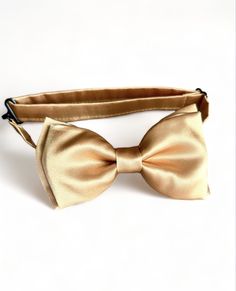 Gold satin pre- tied bow tie. Perfect for your any occasion. Please allow me 2-3 days to make your ties as I don't always have them ready to ship. If you have any questions, please message me. WEDDING ORDERS: Please let me know your wedding date to assure I can meet your deadlines. It take about 5 days to make wedding orders.  INTERNATIONAL ORDERS: Please review shipping policies as first class shipping can take up to 2-4 weeks. Adjustable Satin Bow Tie In Dapper Style, Dapper Adjustable Satin Bow Tie, Adjustable Gold Bow Tie And Suit Accessories, Adjustable Gold Bow Tie And Accessories, Gold Adjustable Bow Tie Suit Accessories, Adjustable Gold Bow Tie, Gold Satin Bow Tie, Adjustable Gold Bow For Black Tie Event, Classic Satin Bow Tie For Gift