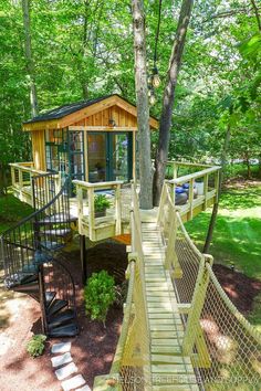 a tree house in the woods with stairs leading up to it