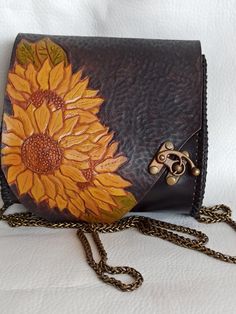 a purse with a sunflower painted on it