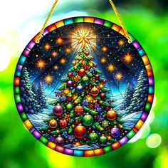 a stained glass ornament with a christmas tree on it