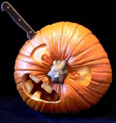 a carved pumpkin with a knife sticking out of it's center and the inside of its mouth