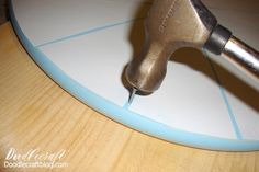 a close up of a tool on top of a surfboard with woodgrain