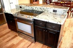 a kitchen with wooden floors and white counter tops