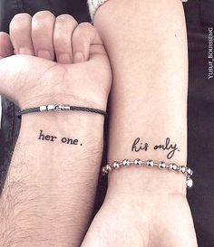 two people holding hands with tattoos on their arms and the words her one, her only