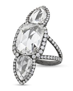 Known as a North-South ring for its vertical design, this exceptional ring features a total of 7.98 carats of white diamonds. The center diamond is cushion shaped with a rose cut and weighs 4.08 carats, while the two pear-shaped, rose-cut side diamonds total 2.63 carats. Circling the larger diamonds and traveling along the band are 1.27 carats of accent diamonds. Set in rhodium-plated 18k gold. Different Diamond Cuts, Types Of Diamond Cuts, Antique Diamond Jewelry, Flawless Diamond, Modern Engagement Rings, Gold Cocktail Ring, Types Of Diamonds, Vertical Design, North South