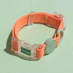 an orange bracelet with a green tag on it