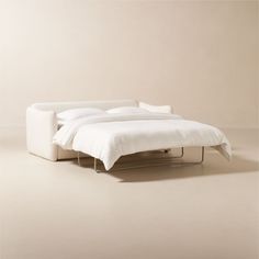 a bed that is sitting on top of a white floor next to a beige wall