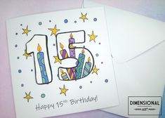 a birthday card with the number fifteen on it and some candles in front of it