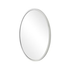 a round mirror on a white wall