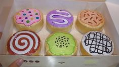 a box filled with assorted decorated donuts