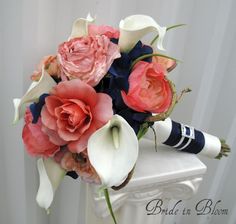 a bouquet of flowers on top of a white pedestal