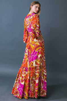 A printed woven maxi dress featuring surplice neckline, long sleeve with smocked cuff, smocked waist band and ruffled hemline Make a bold statement in the Ready for the Spotlight Woven Maxi Dress. This printed maxi features a surplice neckline, long sleeves with smocked cuffs, and a smocked waistband that flatters the figure. The ruffled hemline gives the piece a touch of movement, making it perfect for your next special occasion. Unique and sophisticated, this dress will ensure you make an unfo Chic V-neck Maxi Dress With Smocked Cuffs, Multicolor V-neck Maxi Dress With Smocked Back, V-neck Maxi Dress With Smocked Cuffs, Billowy Long Sleeve Floral Maxi Dress, Fall Maxi Dress With Elastic Waistband And Long Sleeves, Fall Long Sleeve Maxi Dress With Elastic Waistband, Elegant Multicolor Maxi Dress With Elastic Waistband, Pink Printed Maxi Dress For Fall, Fall Pink Printed Maxi Dress