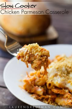 a fork full of chicken parmesan casserole on a white plate