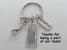 a keychain with a keyboard and thank you written on the front, says thanks for being a part of our team