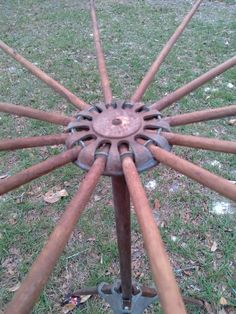 an old metal wheel on the grass