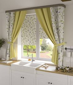 a kitchen window with yellow curtains and green drapes on the windowsill, next to a white sink