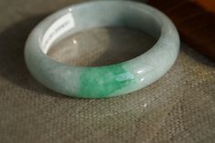 "♡This is a Natural Grade A Burmese (Myanmar) Glutinous with green Jadeite bangle(has a certification in China). ♡Important to know: Has a natural long cotton line and with some black color. ♡It's a finished product, you can get the style and color from the picture. ♡ The bangle Size: about Inner diameter 54.7mm，Width14.5mm, thickness8.7mm. ♡Please note the original colors may be a little bit different from what you see on your monitor. ♡the shop preferential policies: 1. All items are free ship Handmade Elegant Jade Bangle, Carved Jade Bangle Bracelet, Handmade Round Jade Bangle, Handmade Green Jade Bangle, Carved Green Jade Bangle, 100 Grade, Baby Bangles, Tiger Pendant, Shredded Paper