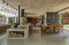 an open kitchen and dining room area with wood accents on the walls, flooring and ceiling