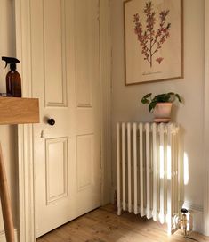 a room with a radiator and a painting on the wall