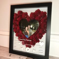 a heart shaped photo frame with roses in it