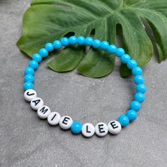 A super cute light blue acrylic name bracelet with your choice of wording and size! Personalise it with your name, your child's name, an inspirational word, your team name, a pet name, a nickname, or anything else you can think of eg Best Nanny, Bridesmaid, or an anniversary date or birth date.The custom made bracelet has 6mm acrylic beads and flat white acrylic letter beads, which are 7mm diameter. It is thread on strong elastic and will stretch a little bit so you can roll it onto your wrist g Acrylic Letters, Pet Name, Flat White, Anniversary Dates, Letter Beads, Team Name, Name Bracelet, Allergy Friendly, White Flats