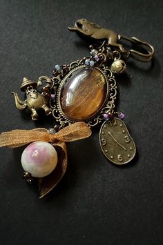 a close up of a keychain with charms on it and a horse figurine