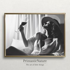 a black and white photo of a woman with a glass of wine in her hand